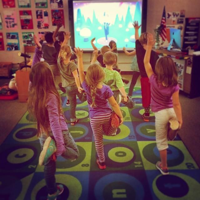 Kids at school practicing with Cosmic Kids!