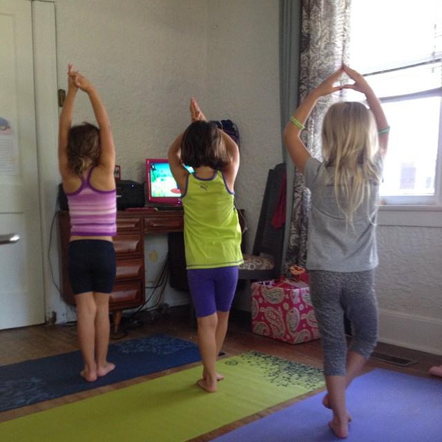 Kids at home practicing Cosmic Kids Yoga!