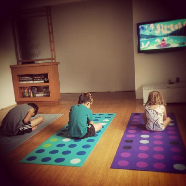 Kids at home practicing Cosmic Kids Yoga!