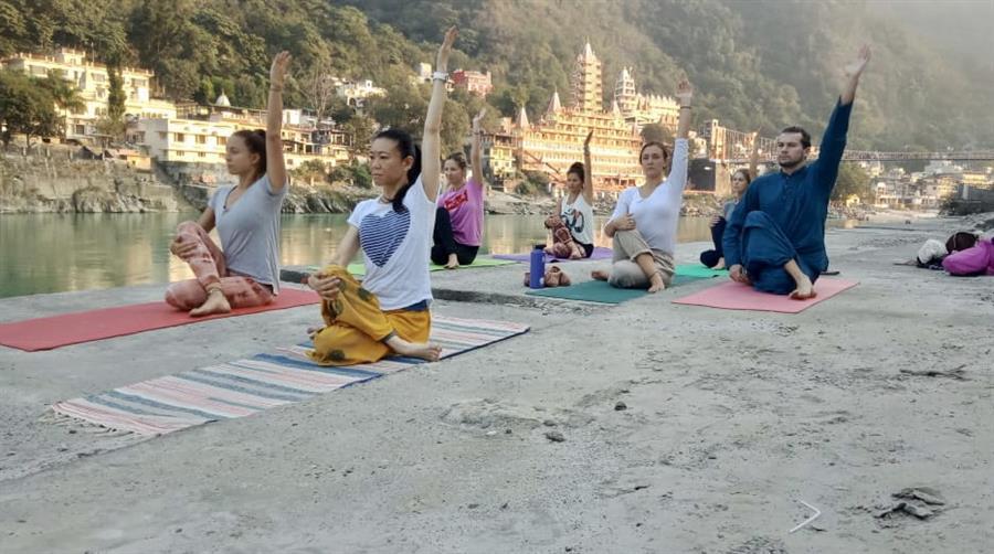 Doing yoga by the Ganga